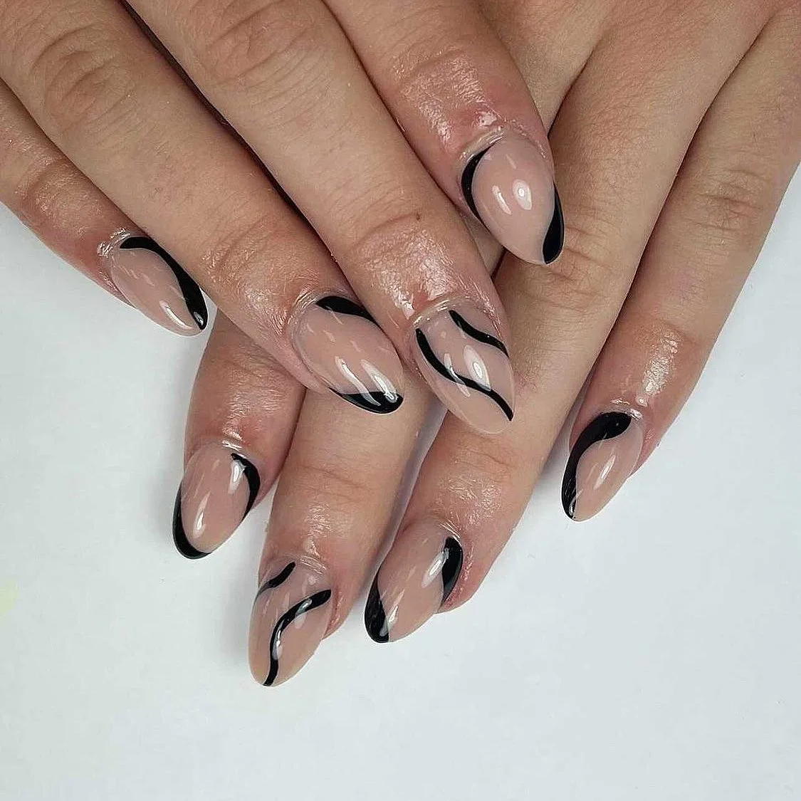 Nude manicure with graphic black French tips