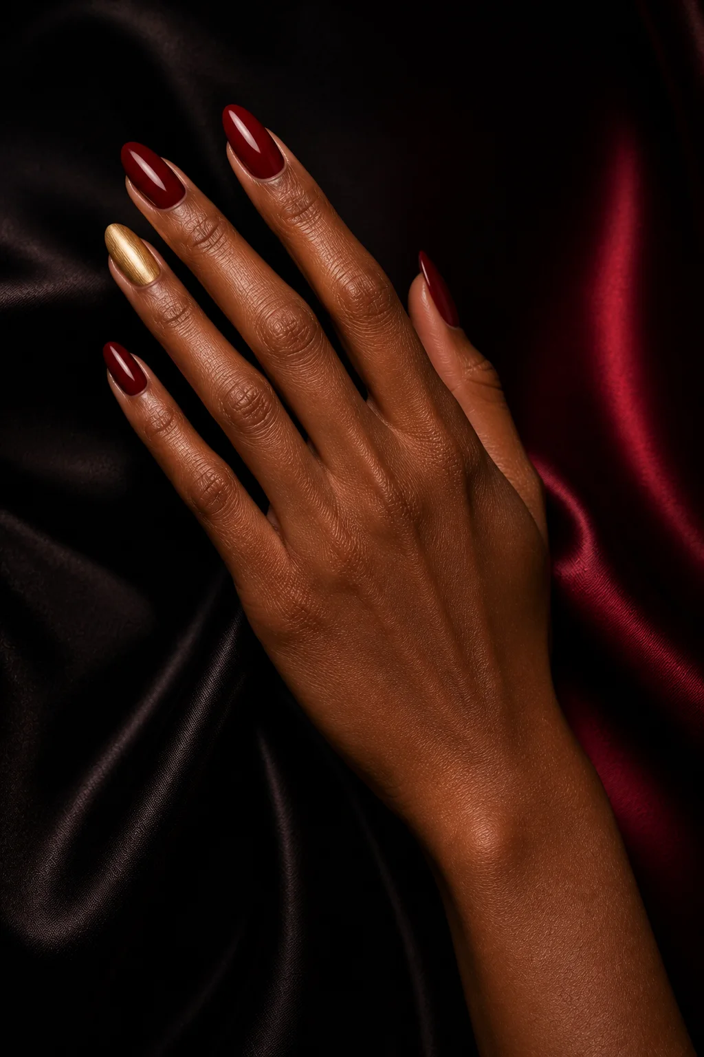 Oxblood manicure with gold accents